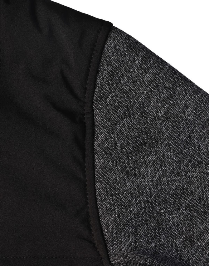 A close-up of a men's jacket featuring a quilted black body and grey heather sleeves, with a logo visible.