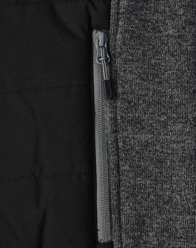 A grey heather fabric with a quilted black interior and a zippered pocket detail. The jacket has a sleek design.