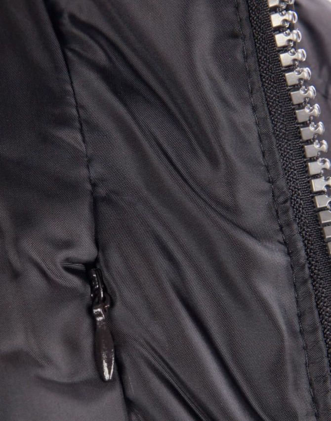 A close-up of a heavy quilted black puffer jacket featuring a zip and a side pocket. It has a logo on the front.