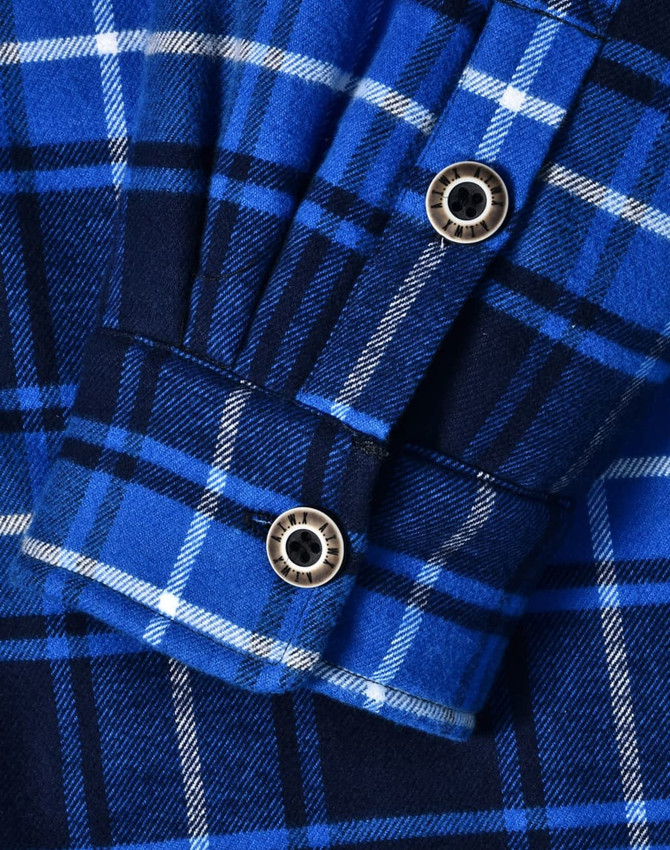 A blue and navy quilted flannel shirt featuring a checked pattern and button details on the cuffs.