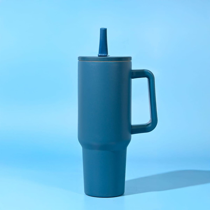 A drink bottle with a dark blue finish, featuring a handle and a straw, set against a light blue background.