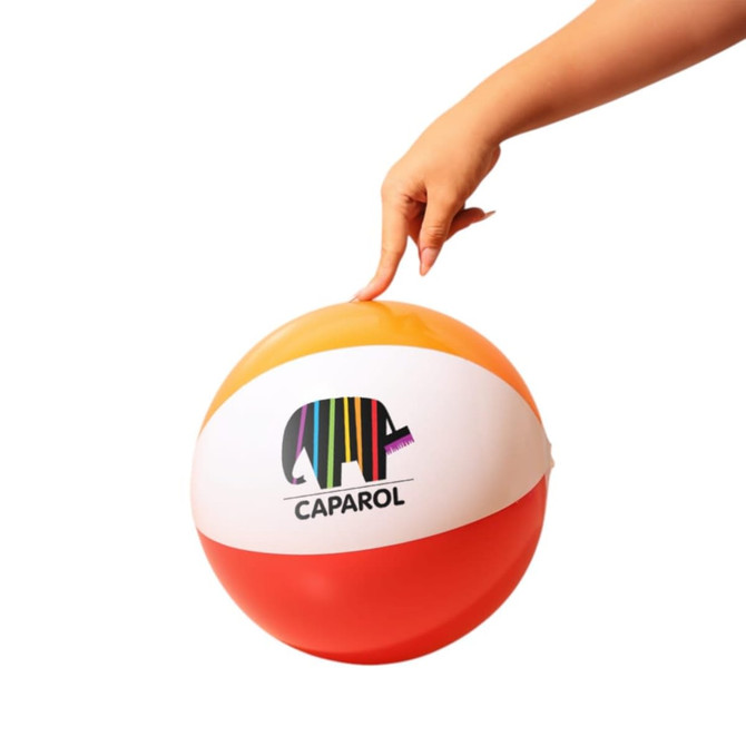 A beach ball featuring orange, white, and red segments with a colourful logo, held by a hand.
