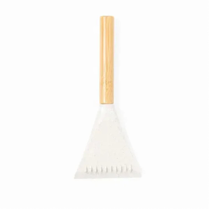 A white ice scraper with a wooden handle, featuring a triangular scraping edge and notched teeth.