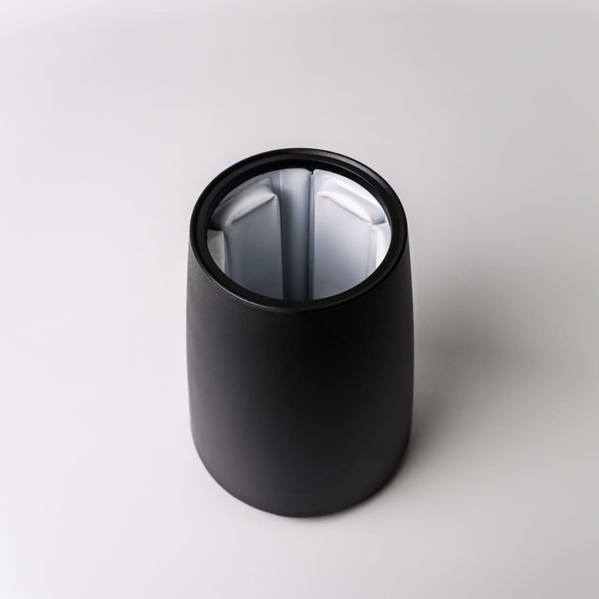 A black ice bucket with a sleek design, featuring a reflective inner surface and a logo.