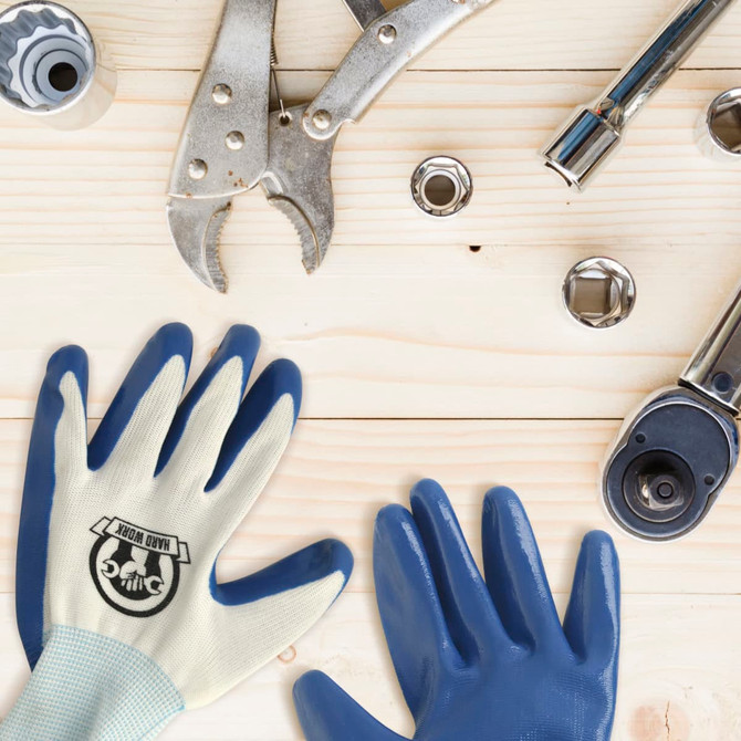 Gardening gloves in light yellow with blue palms, surrounded by various tools on a wooden surface.