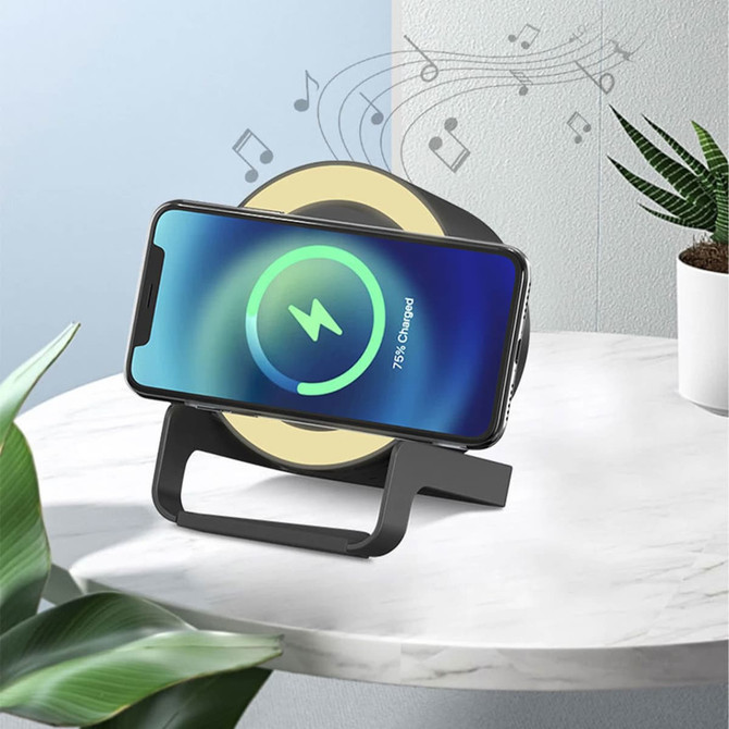 A night light speaker with a wireless charging area in black and white, displaying a phone with charging indicator.
