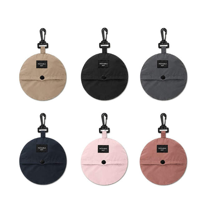 A collection of foldable bucket hats in beige, grey, black, and pink, featuring a logo and clip for attachment.