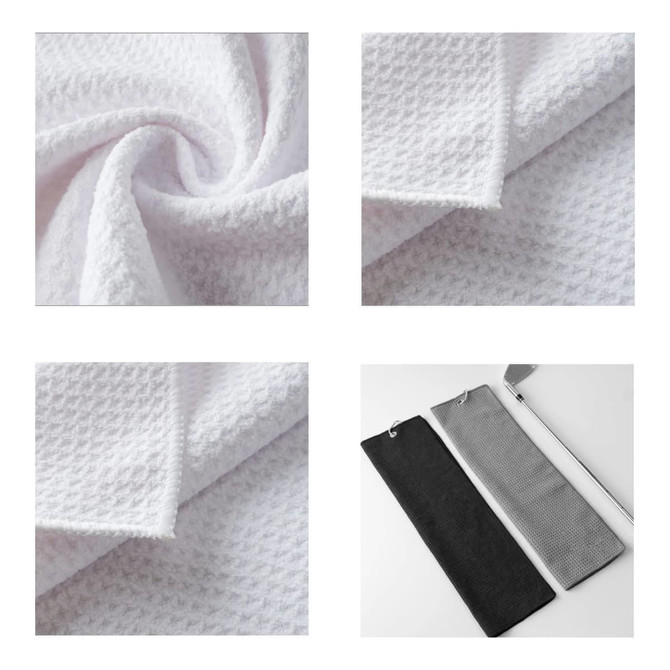 A waffle-textured golf towel in white, folded and displayed with a black and grey towel alongside. Features a branding logo.