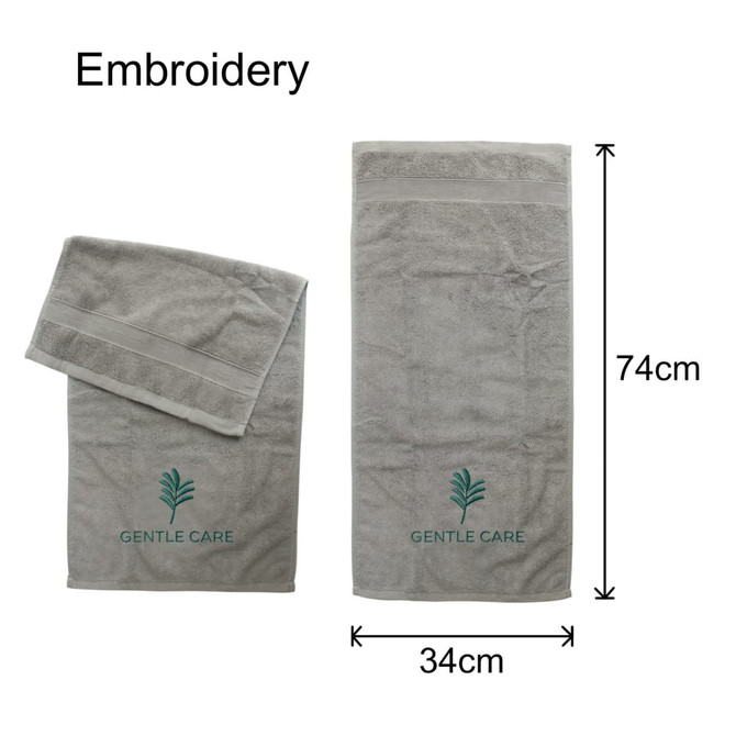 Embroidered cotton hand towels in grey, featuring a logo and two sizes: one large and one small.