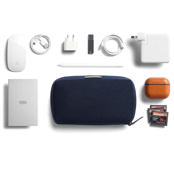 A navy tech kit contains a mouse, chargers, cables, a power bank, and an assortment of memory cards.
