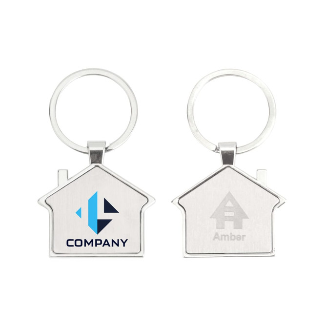 A metal keyring shaped like a house, featuring a logo on one side and a smooth surface on the reverse. Silver in colour.
