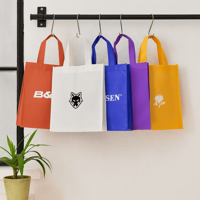 A black tote bag with a red stripe and branding, featuring long handles for easy carrying.