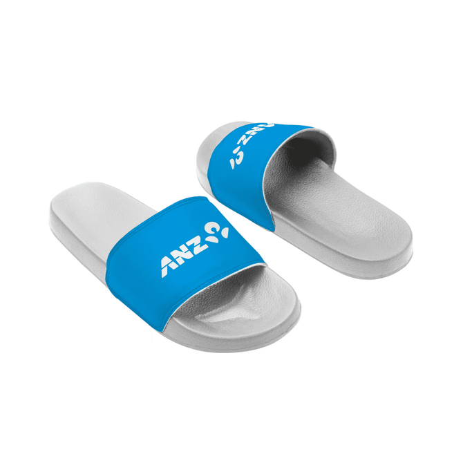 Blue slide sandals featuring a white logo on a blue strap and a grey sole.