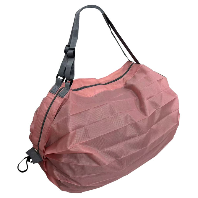 A foldable shopping shoulder bag in a pinkish hue with grey straps, featuring a zip closure and a logo.