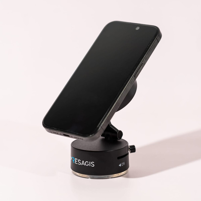 A black vacuum suction magnetic phone stand with a sleek design, featuring a logo on its base.