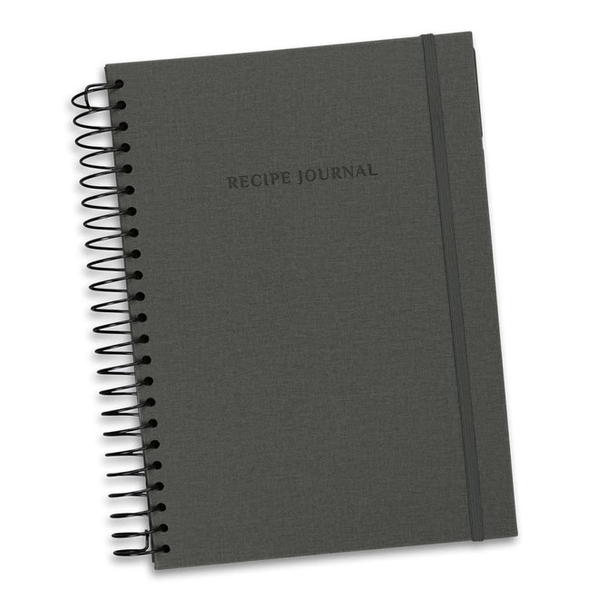 A dark grey recipe journal with a spiral binding and an elastic band, featuring the text "Recipe Journal" on the cover.