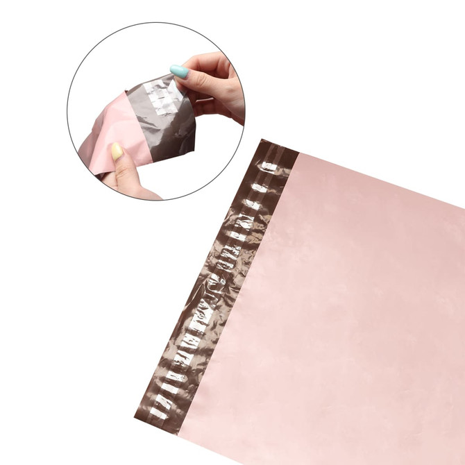 A pink self-sealing plastic mailing bag with a brown strip for easy closure. It includes a logo in the design.