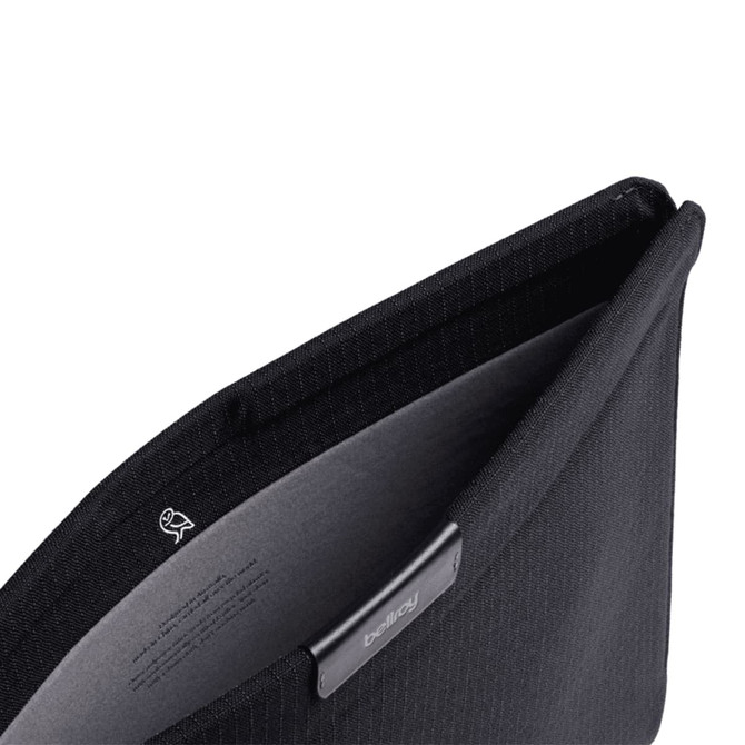 A black laptop sleeve with a soft interior lining and a logo. The opening reveals a sleek design.