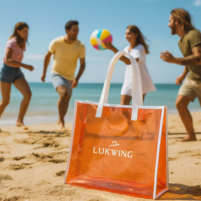 A transparent orange handbag with white handles is in the foreground, while people play on the beach in the background.