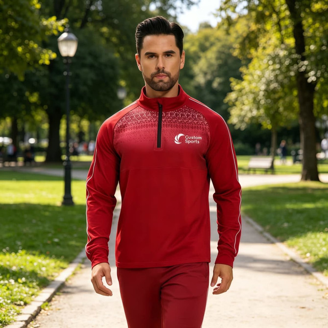 A red polyester spandex jacket with a stand-up collar and 1/4 zip, featuring raglan sleeves and a logo.