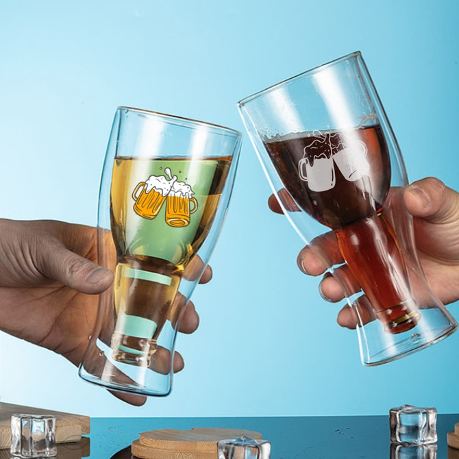 A drink bottle featuring a double wall design, clear glass construction, and a logo. One glass contains a golden liquid, the other a dark liquid.