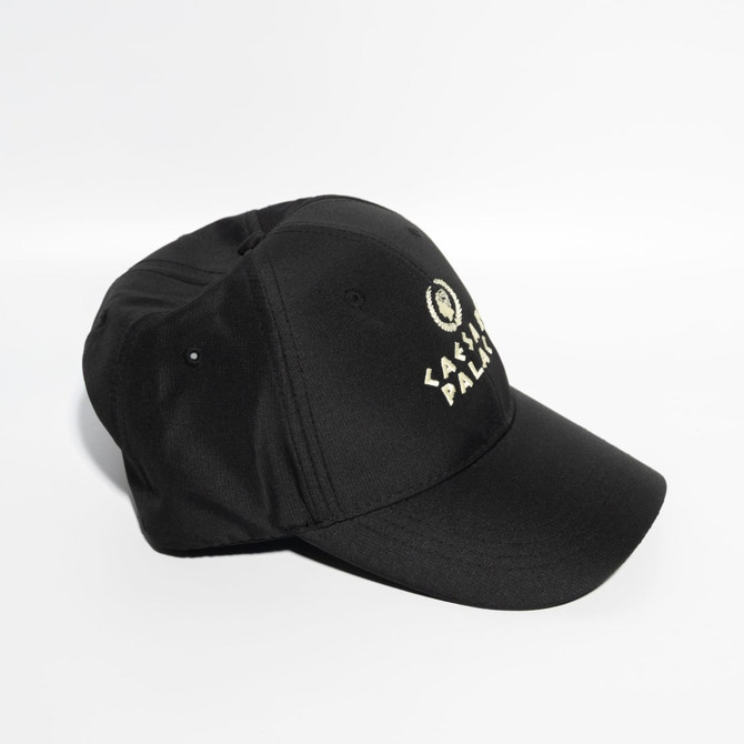 A black baseball cap with a Velcro strap and a logo on the front. Features six panels.