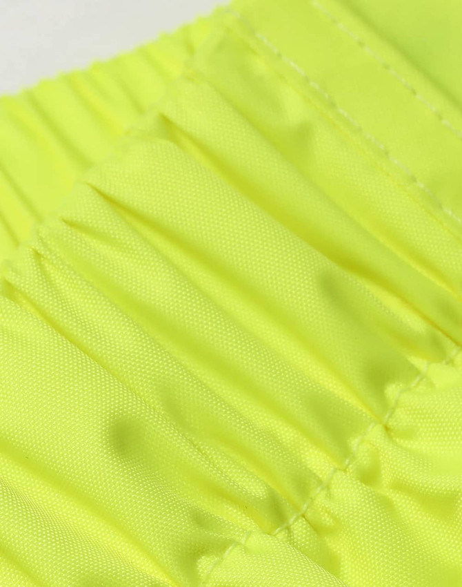 Bright yellow lightweight nylon waterproof rain pants with gathered elastic detail. The fabric appears smooth and durable.