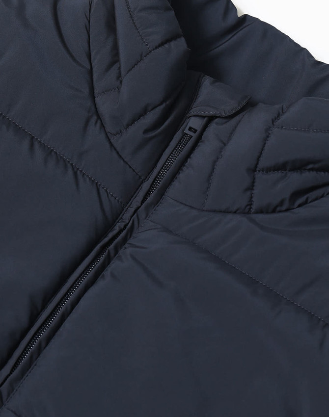 A navy insulated puffer vest featuring a 3D cut with a front zipper and a branded logo.