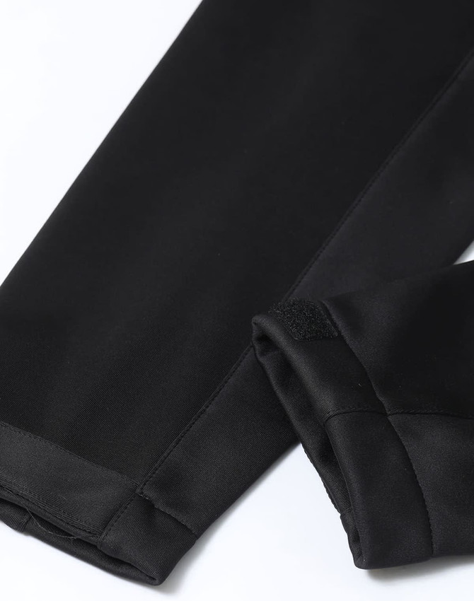 A black softshell corporate jacket with sleek, smooth fabric and finished sleeves. It features a logo on the fabric.