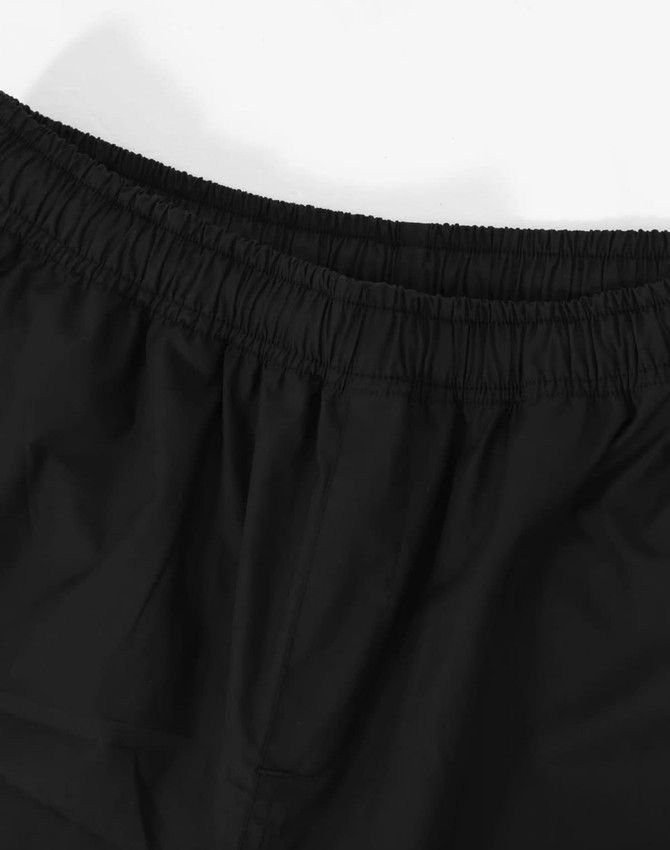 Black unisex shorts with an elastic waistband, featuring a smooth texture and minimal detailing.