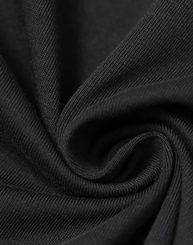A close-up of black cotton fabric, showcasing its soft texture and fine weave. The fabric is arranged in a spiral.