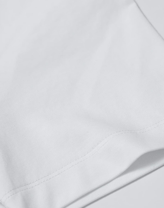 A close-up of a white premium cotton short sleeve tee shirt featuring a stitched hem and a logo.