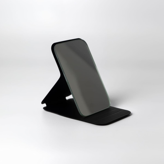 A pocket mirror in a sleek, black foldable design, featuring a reflective surface.