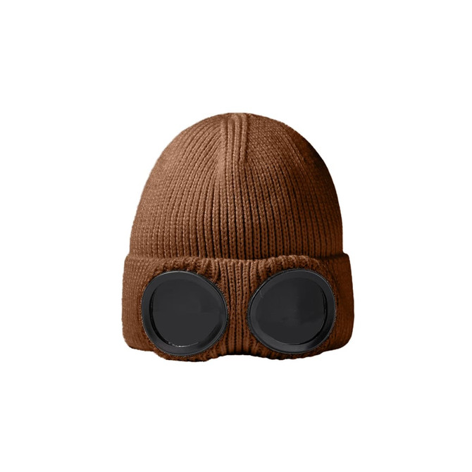 A brown beanie with black goggles attached at the front, displaying a knitted texture.