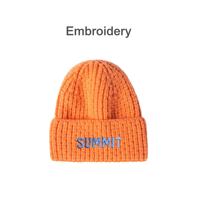 An orange twisted cable cuffed beanie with a single logo on the front.