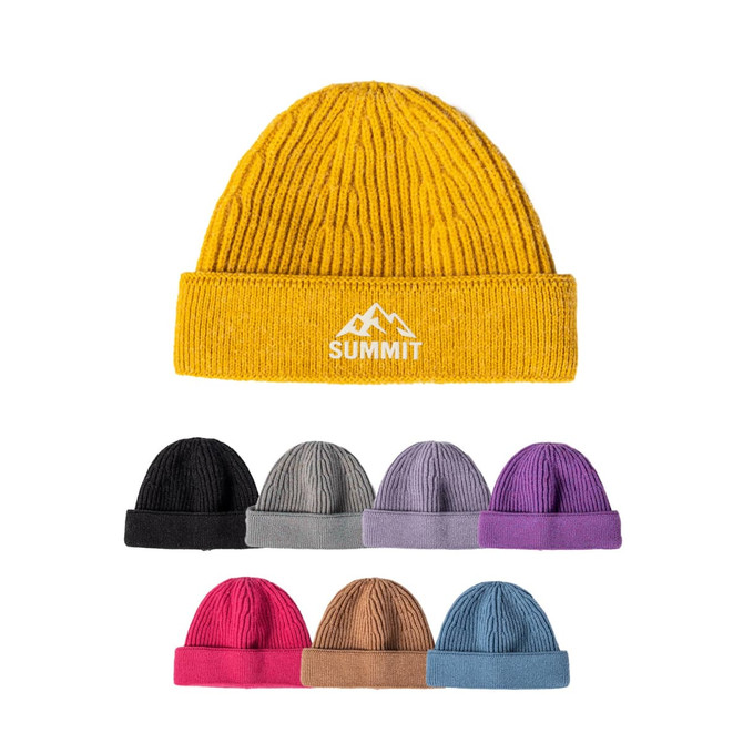 A round beanie in mustard yellow, featuring a logo, with additional beanies in black, grey, purple, and pink.