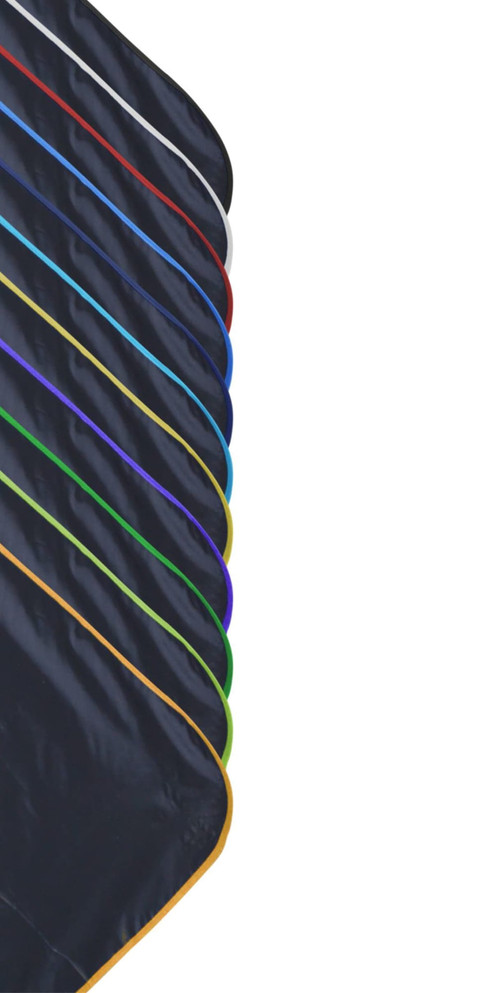 A compact picnic mat with a black surface and various coloured edges, featuring a branding logo.