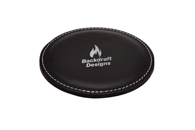 A round black coaster with a stitched edge and a logo in the centre.