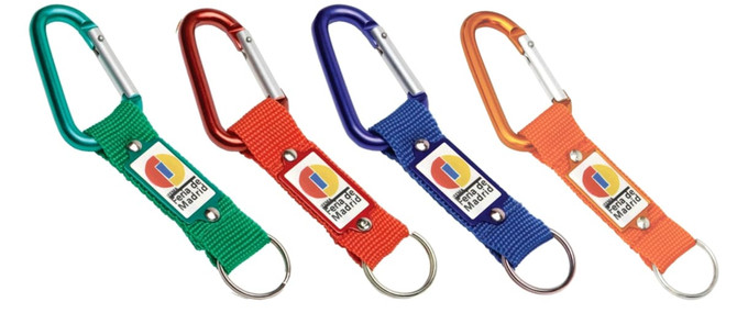 A set of four keyrings with colourful carabiners and fabric straps, featuring a logo on each.