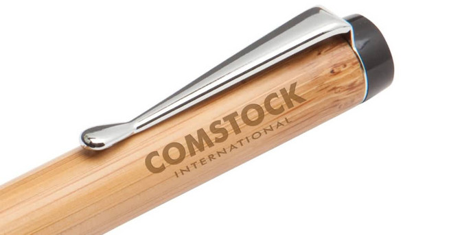 A bamboo pen with a shiny silver clip and a branding logo on the barrel.