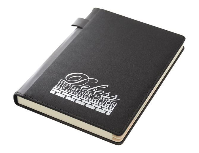 A black A5 notebook with a textured cover and a logo. It features a strap closure and cream-coloured pages.
