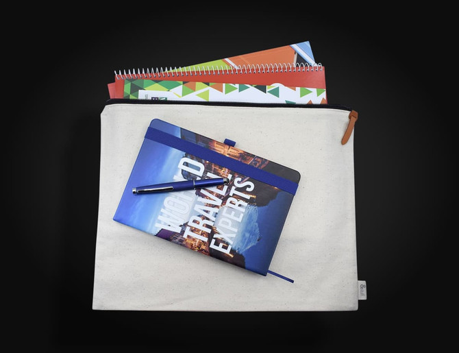 A cream conference bag with a zipper, featuring a notebook on top and several notepads peeking out.