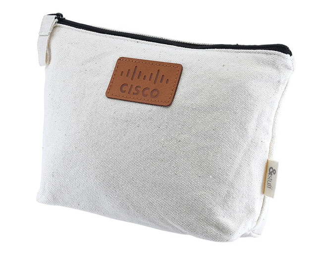 A cream toiletry or makeup bag with a leather-like patch and a zipper closure, featuring a logo.