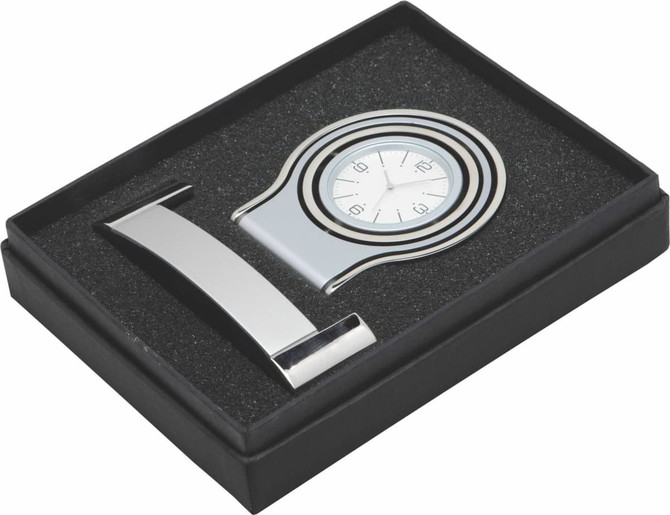 A deluxe gift box containing a silver watch and a metal clip, presented on black foam padding in a black box.