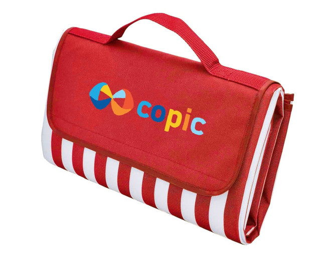 A red picnic rug with a striped pattern and a handle, featuring a logo on the front.