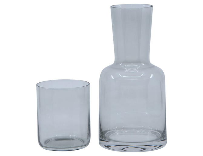A glass carafe and matching tumbler set in clear glass, featuring a sleek design. The set includes one carafe and one tumbler.