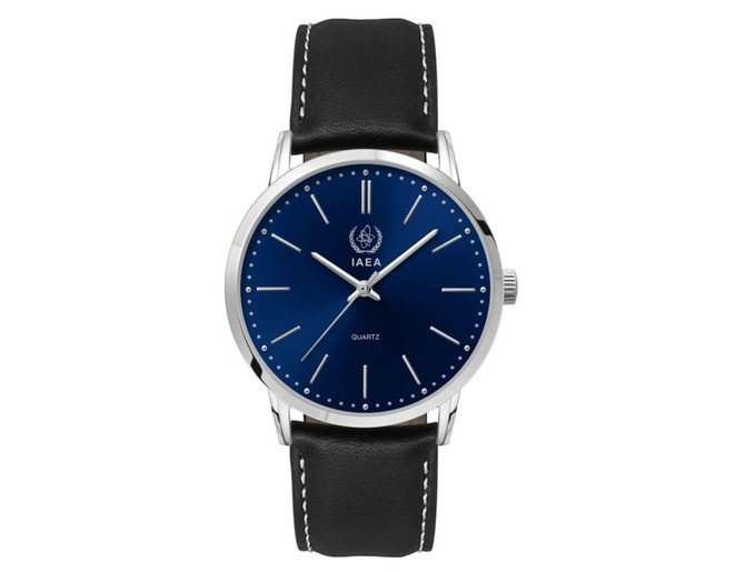A men's dress watch with a blue dial and silver-tone hands, featuring a black leather strap and a logo.