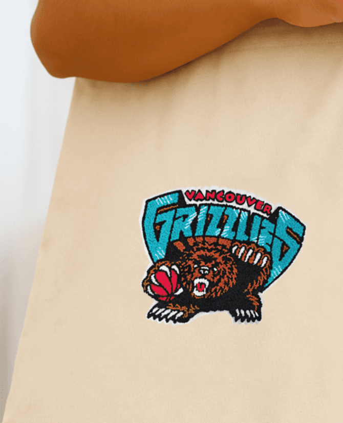 A natural tote bag featuring an embroidered Vancouver Grizzlies logo in blue, black, and brown.