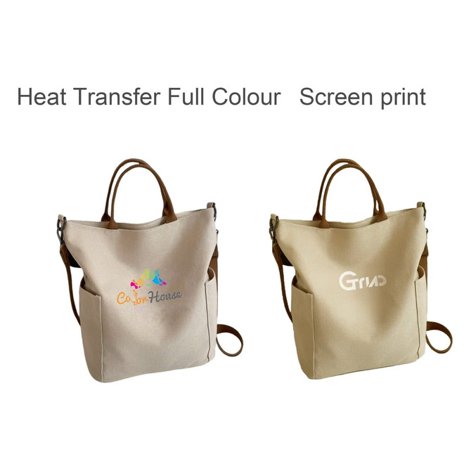 A vintage style canvas bag in beige with dual handles and a logo. Features options for heat transfer and screen print.