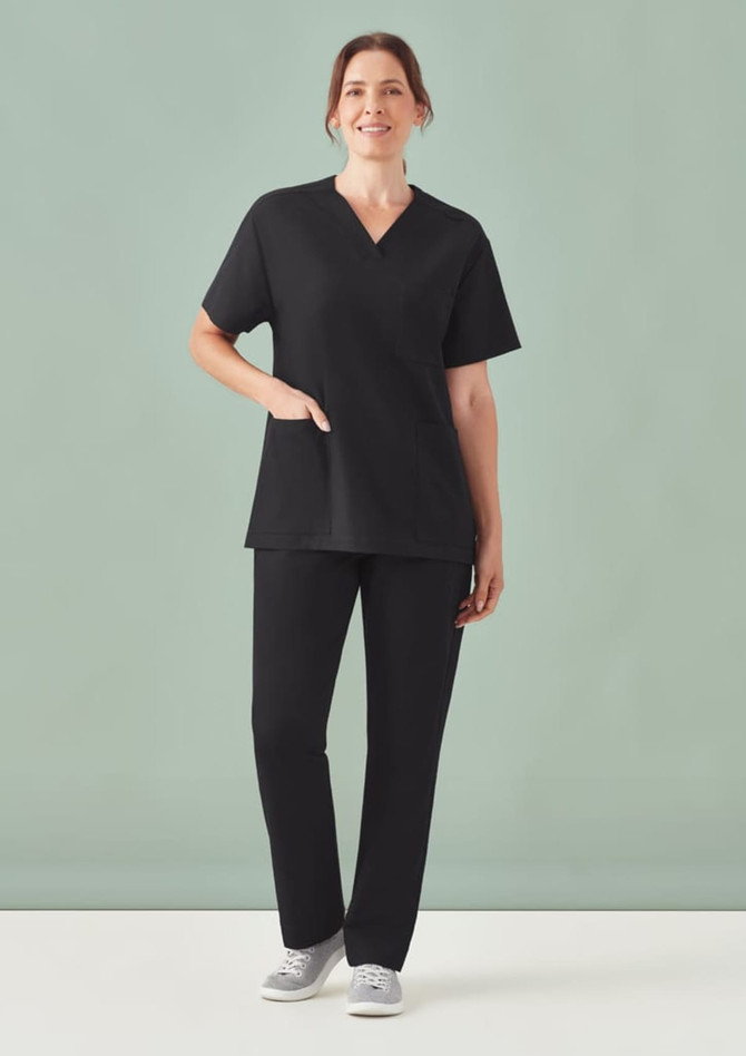 Unisex black V-neck scrub top with short sleeves, paired with matching black scrub pants and casual shoes.